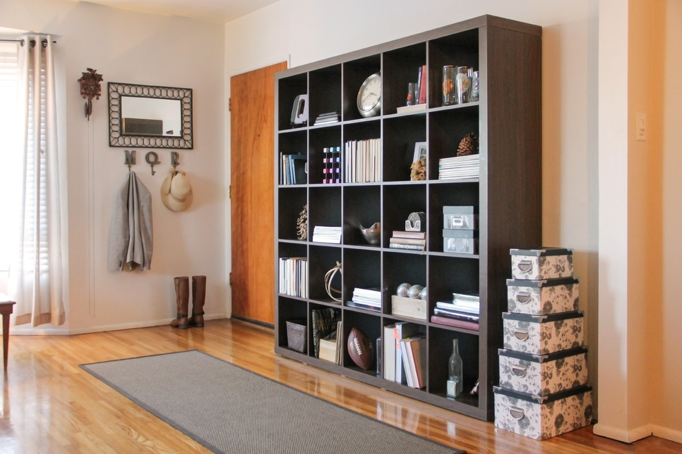 Inspiration for a small transitional medium tone wood floor and brown floor front door remodel in Los Angeles with white walls and a medium wood front door