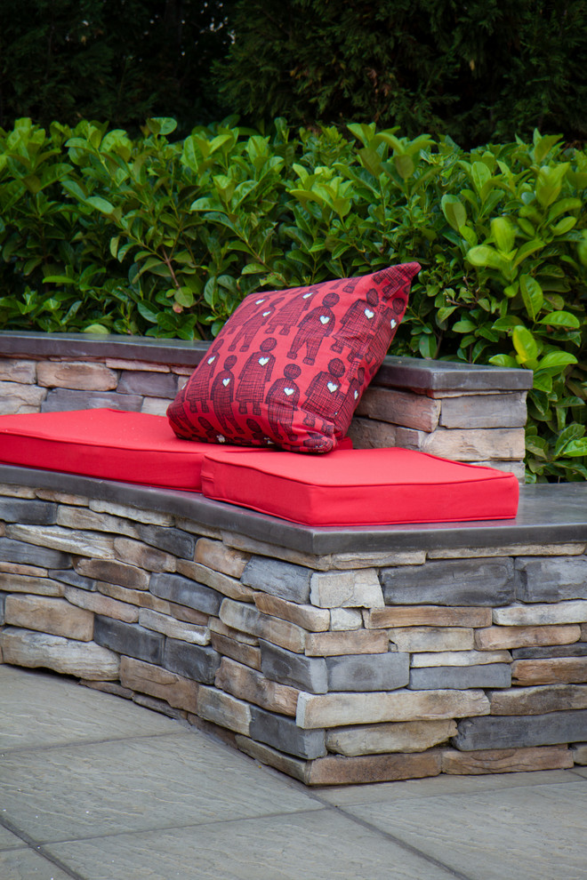 Photo of a rustic full sun backyard concrete paver landscaping.