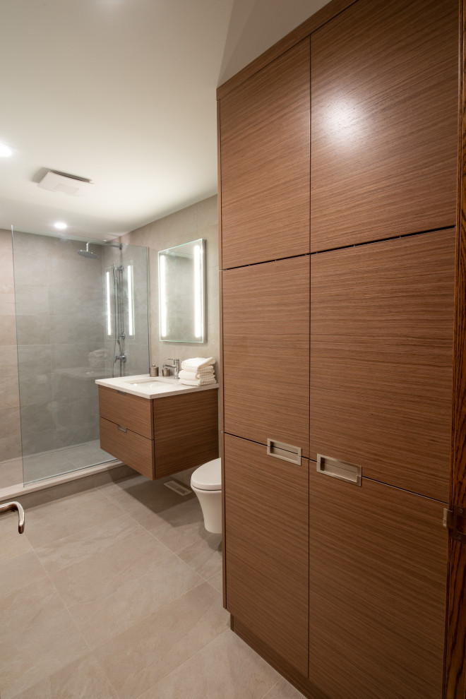 Photo of a mid-sized modern 3/4 bathroom in Milwaukee with flat-panel cabinets, medium wood cabinets, an open shower, a wall-mount toilet, beige tile, porcelain tile, beige walls, porcelain floors, an undermount sink, engineered quartz benchtops, beige floor, an open shower, white benchtops, a single vanity and a floating vanity.