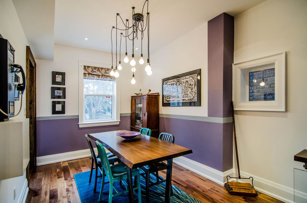 Photo of a contemporary dining room in Toronto with purple walls and medium hardwood floors.