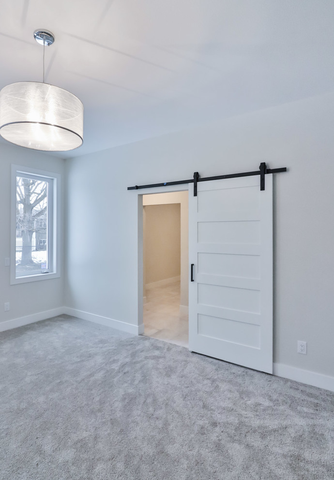 Mid-sized transitional master carpeted and gray floor bedroom photo with gray walls