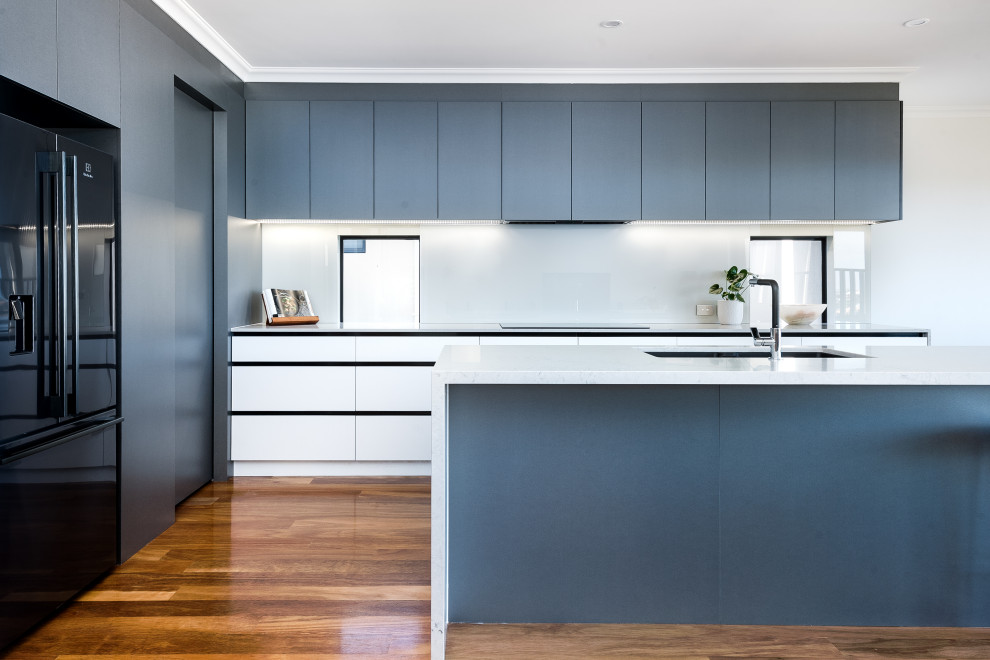 This is an example of a mid-sized contemporary kitchen in Perth with grey cabinets, quartz benchtops and with island.