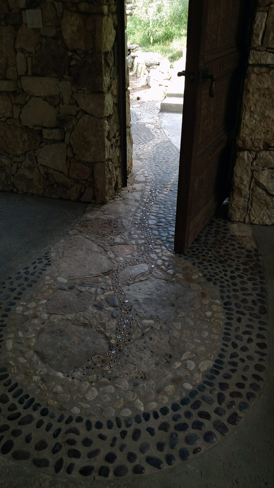 Entryway - eclectic concrete floor entryway idea