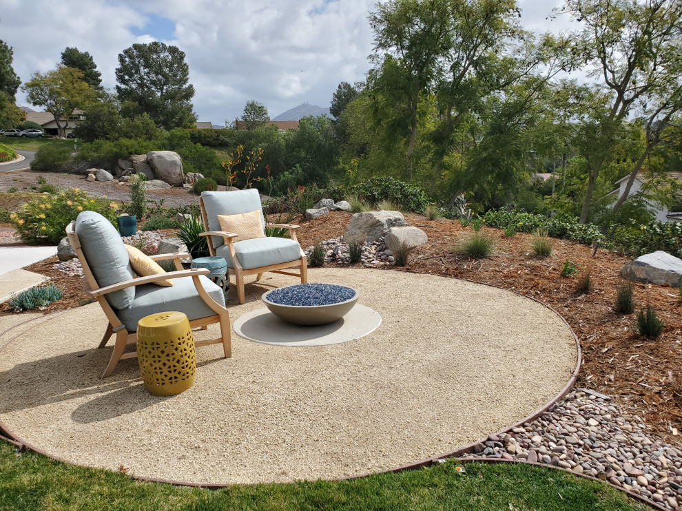 Inspiration for a mid-sized and desert look eclectic backyard full sun xeriscape for summer in San Diego with natural stone pavers.