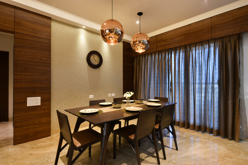 Photo of a contemporary dining room in Bengaluru with beige walls and beige floor.
