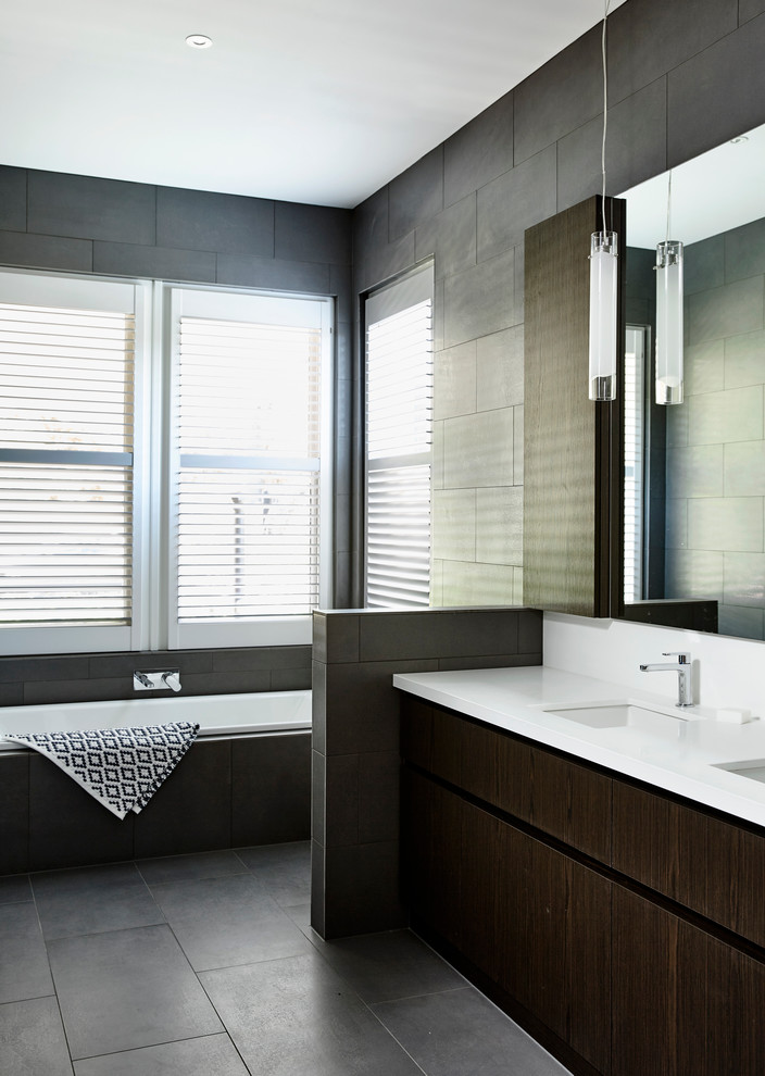 This is an example of a mid-sized contemporary bathroom in Melbourne with an open shower, a one-piece toilet, gray tile, ceramic tile, grey walls, ceramic floors, an undermount sink and engineered quartz benchtops.