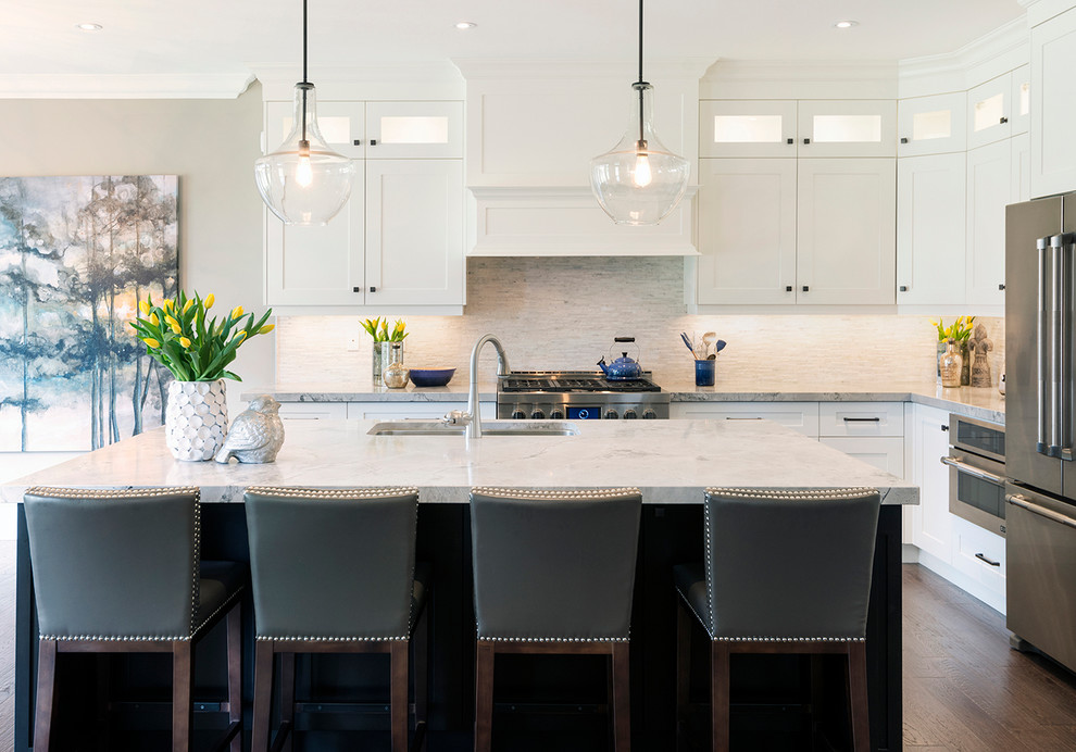 Example of a large transitional l-shaped dark wood floor open concept kitchen design in Toronto with an undermount sink, recessed-panel cabinets, white cabinets, quartzite countertops, multicolored backsplash, mosaic tile backsplash, stainless steel appliances and an island