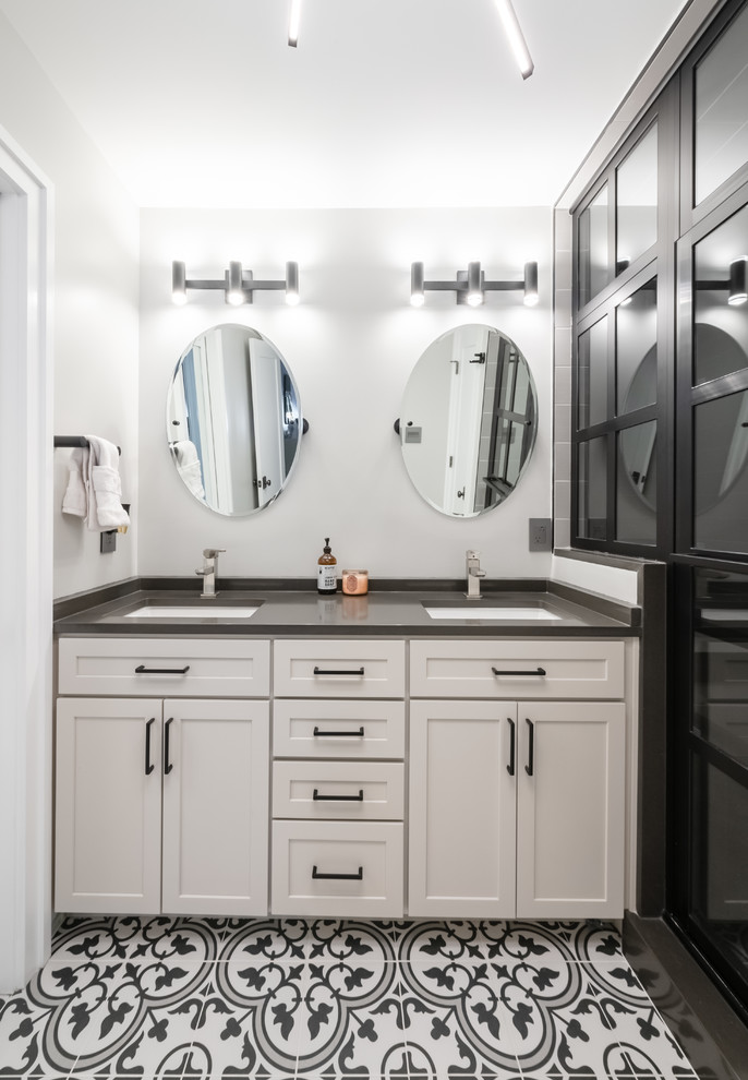 Inspiration for a mid-sized contemporary bathroom in DC Metro with shaker cabinets, grey cabinets, an alcove shower, grey walls, ceramic floors, an undermount sink, engineered quartz benchtops, multi-coloured floor, a hinged shower door and grey benchtops.
