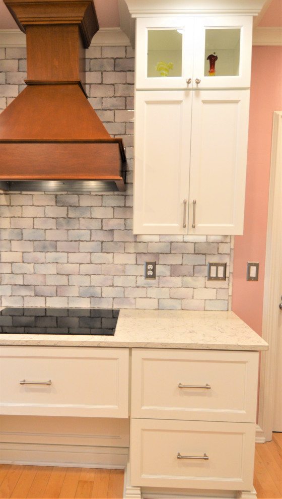 Kitchen - small transitional light wood floor kitchen idea in Milwaukee with a single-bowl sink, shaker cabinets, white cabinets, quartzite countertops, ceramic backsplash and stainless steel appliances