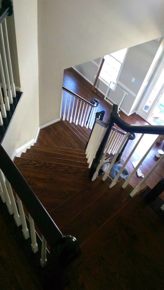 Example of a mid-sized transitional wooden curved staircase design in Baltimore with wooden risers