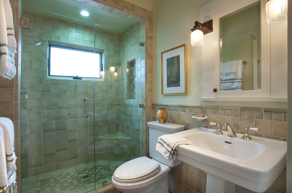 Design ideas for a mid-sized arts and crafts 3/4 bathroom in San Diego with a console sink, an alcove shower, a one-piece toilet, beige tile, terra-cotta tile, green walls, quartzite benchtops and a hinged shower door.