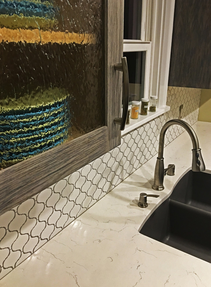 Example of a small transitional galley enclosed kitchen design in Seattle with an undermount sink, shaker cabinets, gray cabinets, quartzite countertops, white backsplash, ceramic backsplash, stainless steel appliances and no island