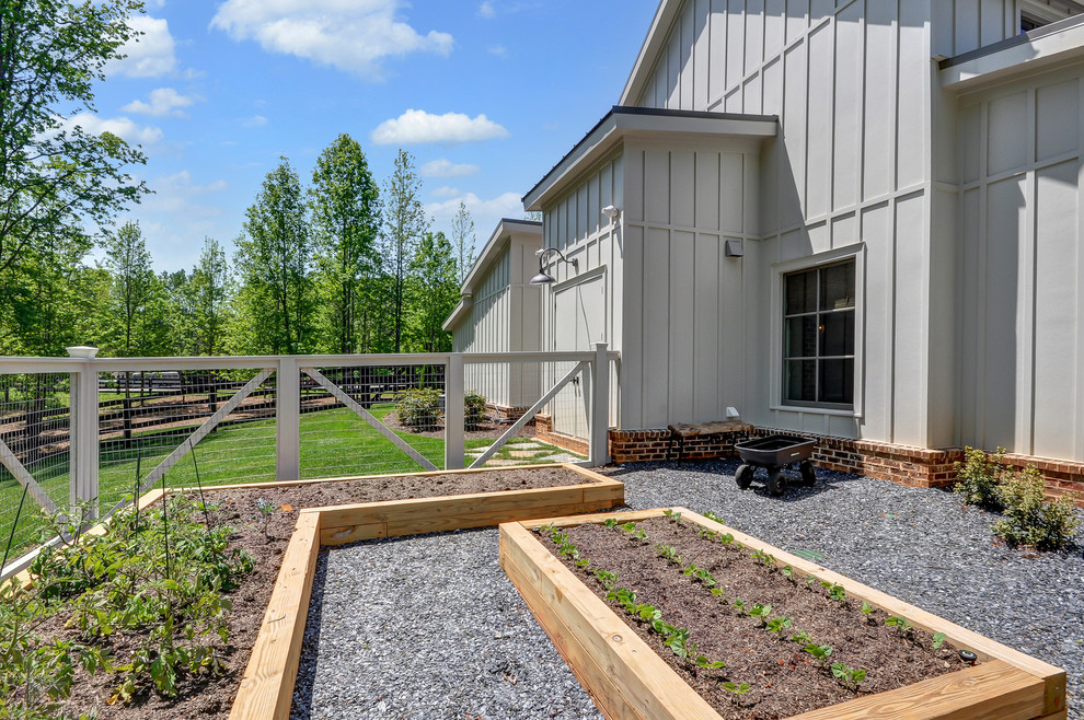 This is an example of a country full sun garden in Atlanta with a vegetable garden and gravel.