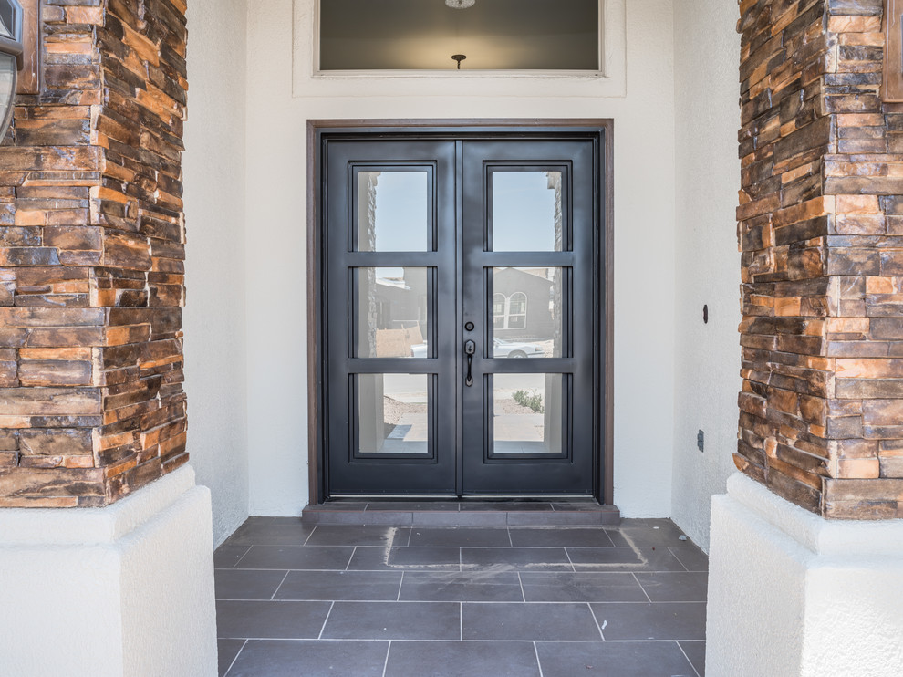 Inspiration for a mid-sized transitional one-story mixed siding ceramic tile front door remodel in Austin with a hip roof and a black front door