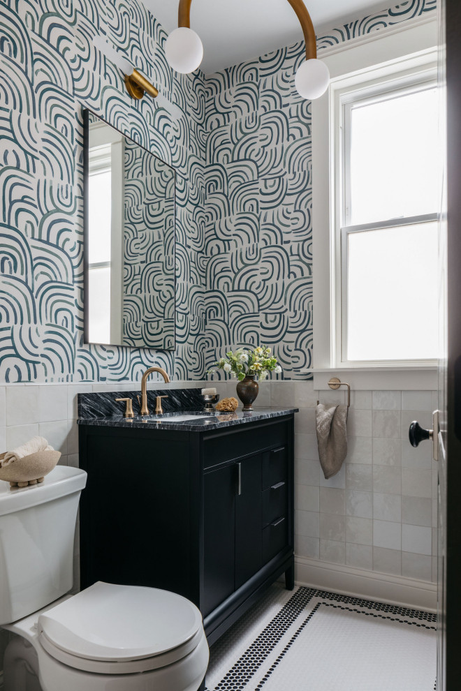 Inspiration for a mid-sized transitional bathroom in Chicago with black cabinets, white tile, ceramic tile, multi-coloured walls, mosaic tile floors, quartzite benchtops, multi-coloured floor, black benchtops, a single vanity, wallpaper, flat-panel cabinets, a two-piece toilet, an undermount sink and a freestanding vanity.