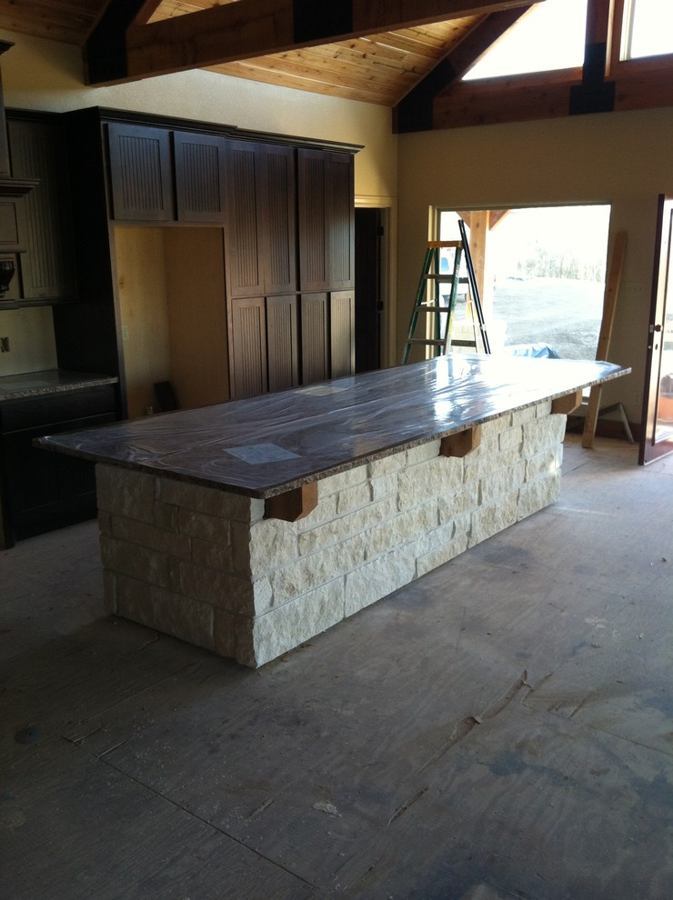 Open concept kitchen - large rustic l-shaped open concept kitchen idea in Houston with shaker cabinets, dark wood cabinets, granite countertops and an island