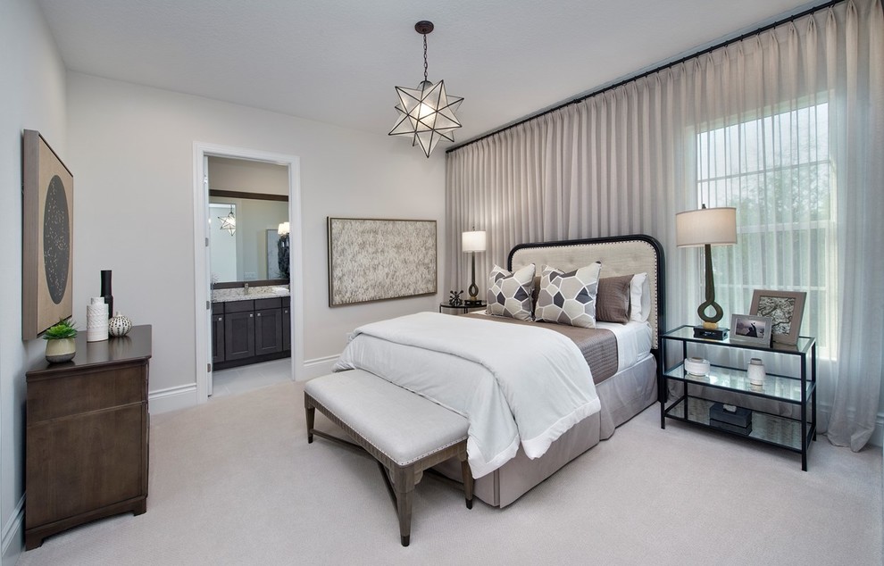 Photo of a beach style master bedroom in Miami with beige walls, carpet and white floor.