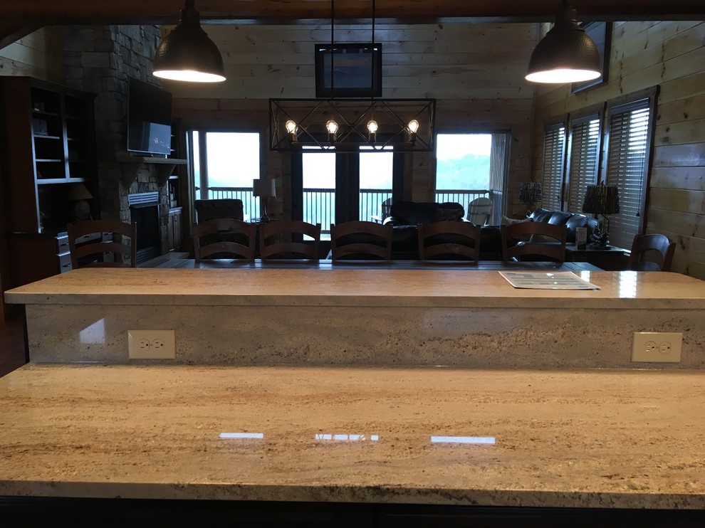 Eat-in kitchen - rustic l-shaped laminate floor and brown floor eat-in kitchen idea with a double-bowl sink, flat-panel cabinets, dark wood cabinets, granite countertops, black backsplash, stainless steel appliances, an island and black countertops