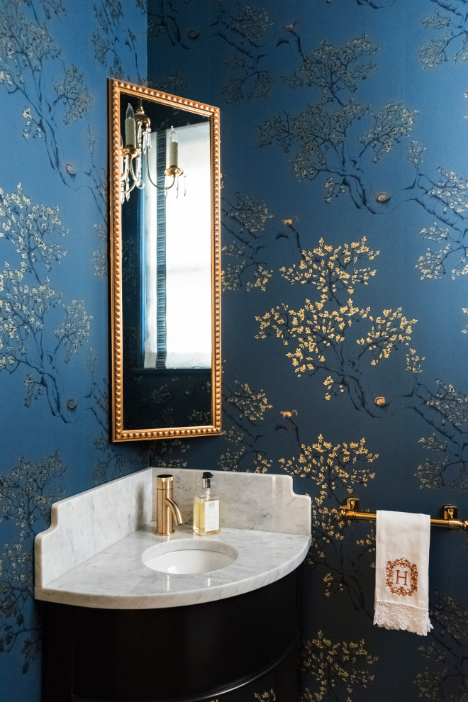 Powder room - small traditional powder room idea in Austin with black cabinets, blue walls, an undermount sink, marble countertops and white countertops