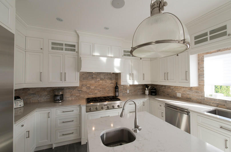 Transitional porcelain tile and gray floor eat-in kitchen photo in Toronto with an undermount sink, beaded inset cabinets, white cabinets, quartzite countertops, brick backsplash, stainless steel appliances, an island and white countertops