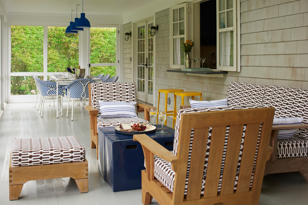 Inspiration for a mid-sized beach style backyard screened-in verandah in New York with decking and a roof extension.