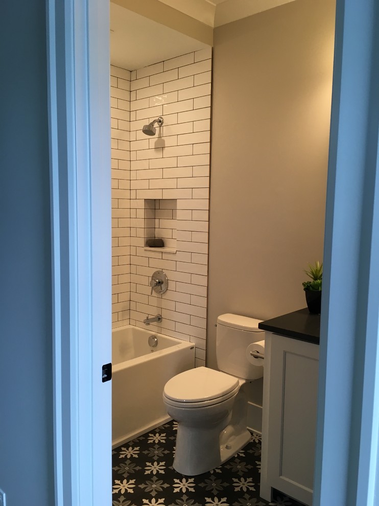Home design - mid-sized transitional kids' white tile and ceramic tile porcelain tile and multicolored floor home design idea in Chicago with shaker cabinets, white cabinets, a two-piece toilet, gray walls, an undermount sink, quartz countertops and black countertops