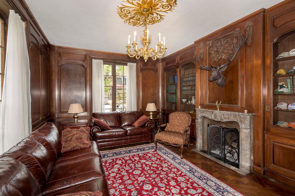Photo of a traditional study room in Philadelphia with medium hardwood floors, a standard fireplace, a stone fireplace surround and a freestanding desk.