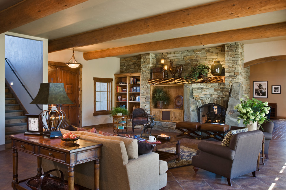 Design ideas for a large country enclosed family room in Other with beige walls, terra-cotta floors, a two-sided fireplace, a stone fireplace surround and a wall-mounted tv.