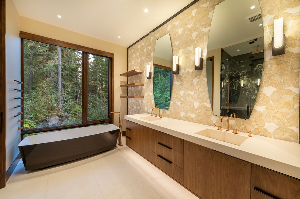 Large contemporary master bathroom in Other with flat-panel cabinets, brown cabinets, a freestanding tub, a curbless shower, white tile, mosaic tile, limestone floors, an integrated sink, limestone benchtops, beige floor, a hinged shower door, beige benchtops, a niche, a double vanity and a built-in vanity.
