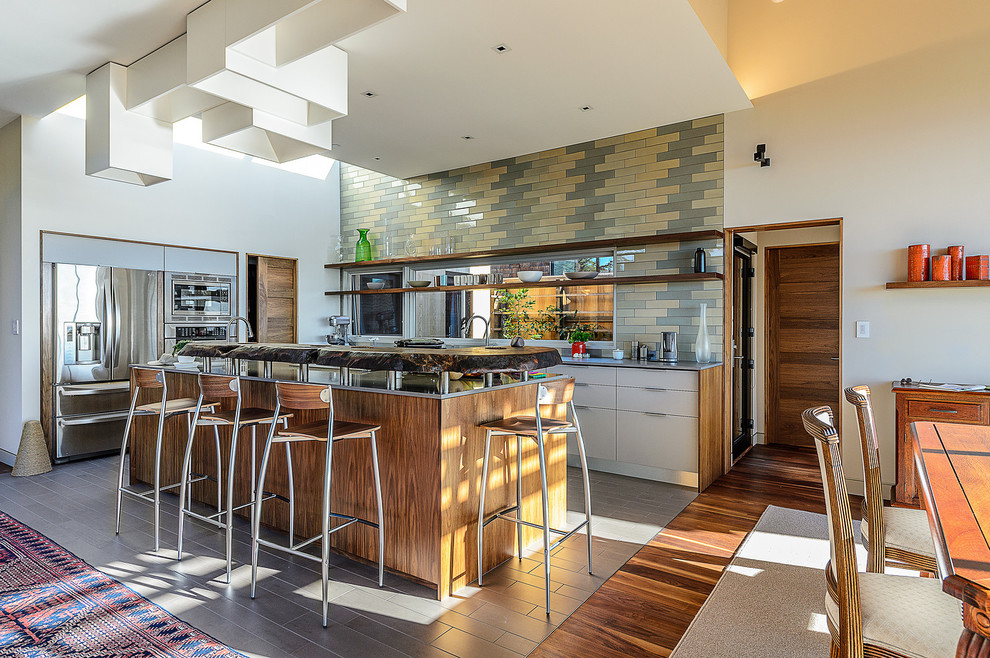 Photo of a midcentury u-shaped eat-in kitchen in San Francisco with stainless steel appliances, open cabinets, wood benchtops and multi-coloured splashback.