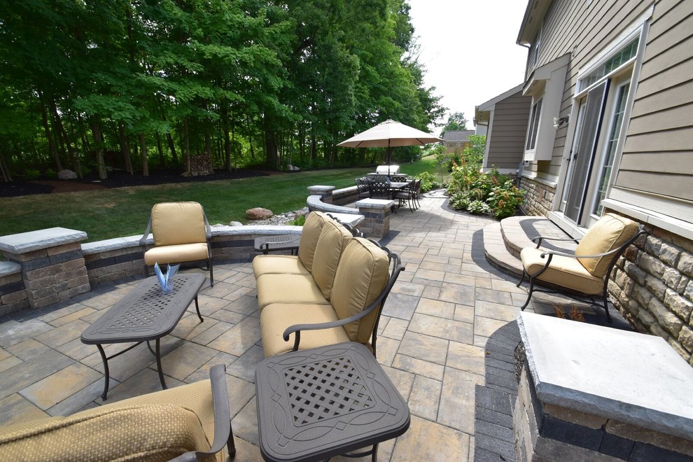 Large traditional backyard patio in Columbus with concrete pavers.