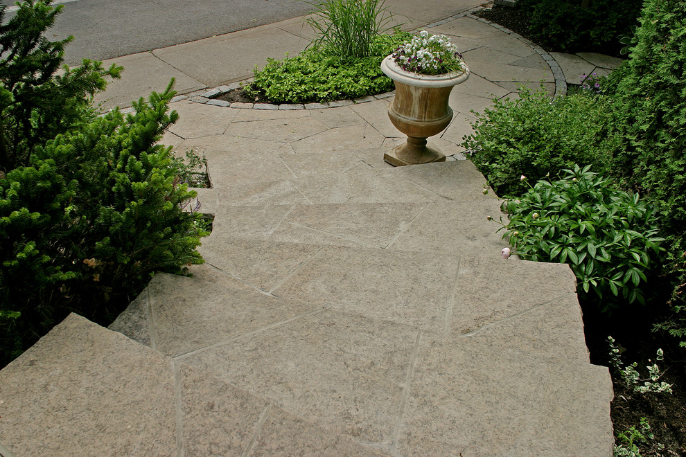 Design ideas for a small transitional front yard partial sun garden for summer in Toronto with a garden path and natural stone pavers.