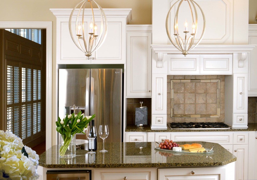 Mid-sized transitional medium tone wood floor eat-in kitchen photo with raised-panel cabinets, white cabinets, granite countertops, beige backsplash, ceramic backsplash, stainless steel appliances and an island