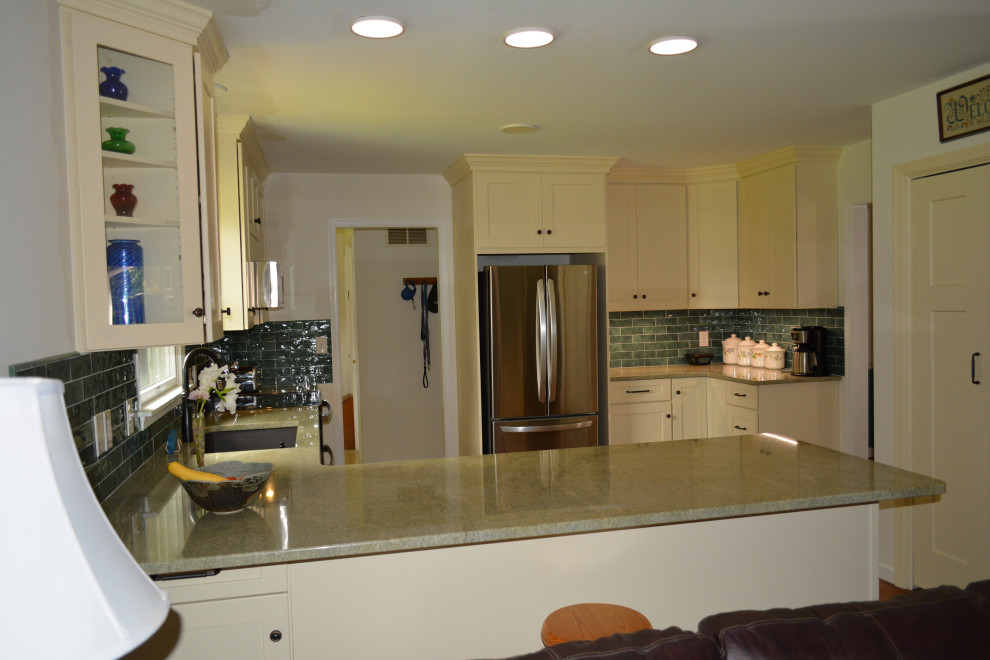 This is an example of a small classic u-shaped enclosed kitchen in Other with a submerged sink, flat-panel cabinets, white cabinets, granite worktops, black splashback, metro tiled splashback, stainless steel appliances, a breakfast bar and green worktops.