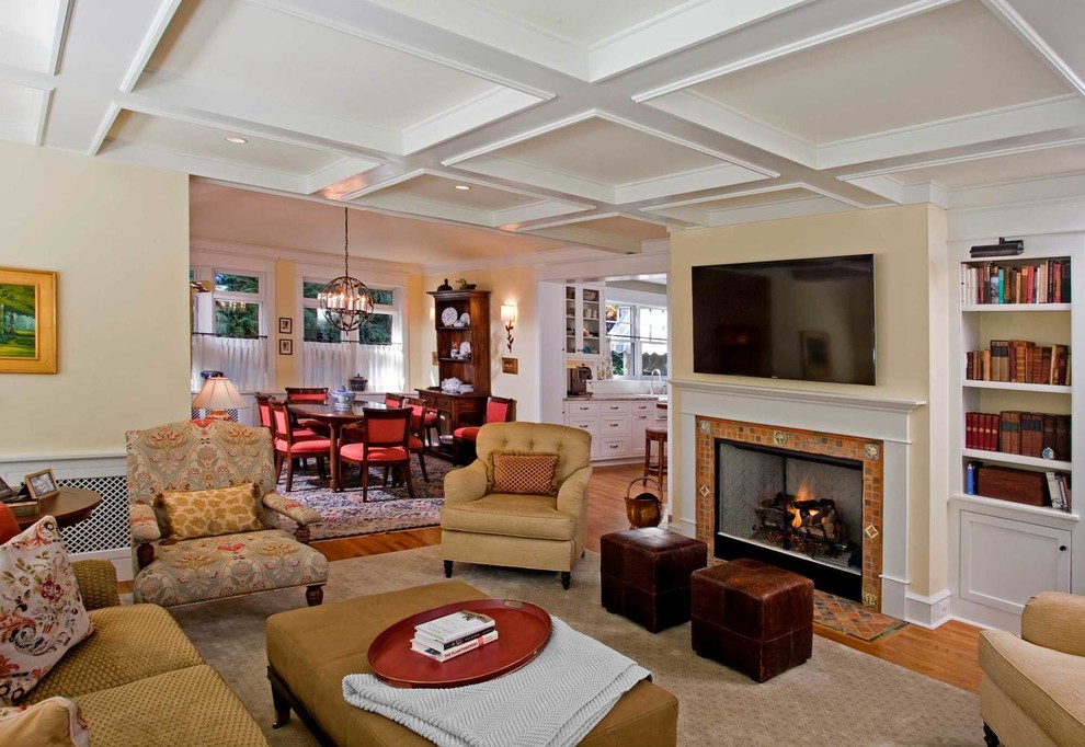 This is an example of a large traditional enclosed family room in Philadelphia with beige walls, medium hardwood floors, a standard fireplace, a wall-mounted tv, a tile fireplace surround and white floor.