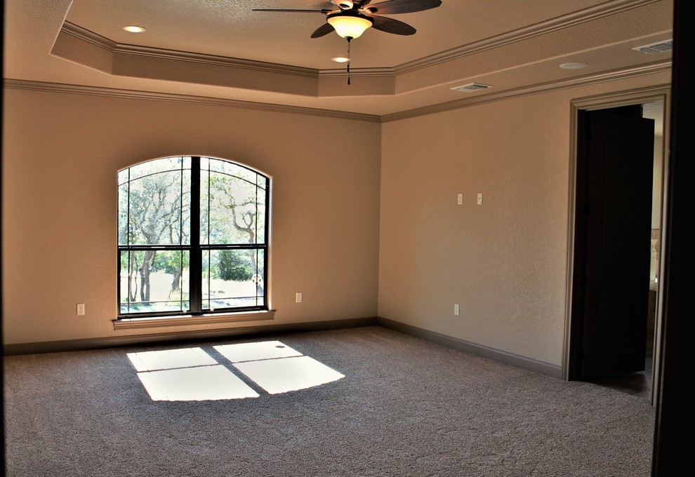 Photo of a large traditional master bedroom in Other with beige walls, carpet and beige floor.