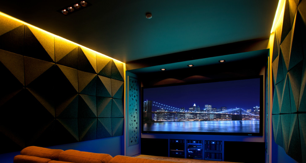 Home theater - large modern enclosed carpeted and beige floor home theater idea in New York with gray walls and a projector screen