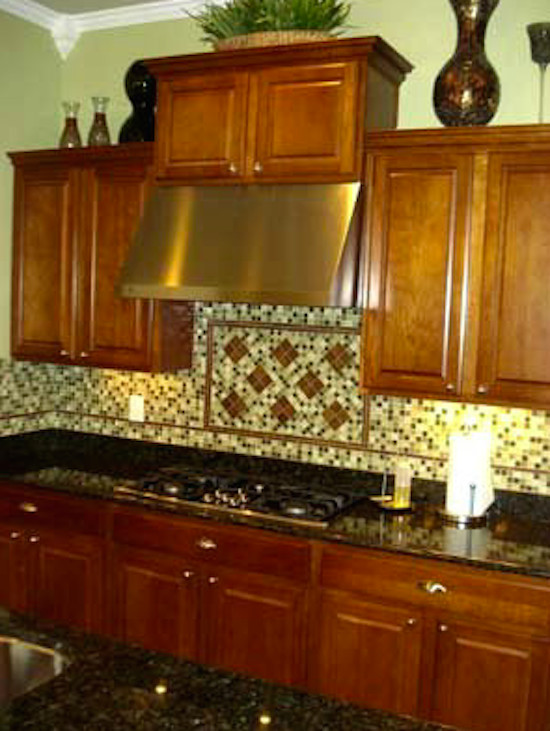 Inspiration for a ceramic tile kitchen remodel in Phoenix with medium tone wood cabinets, granite countertops, black appliances and an island