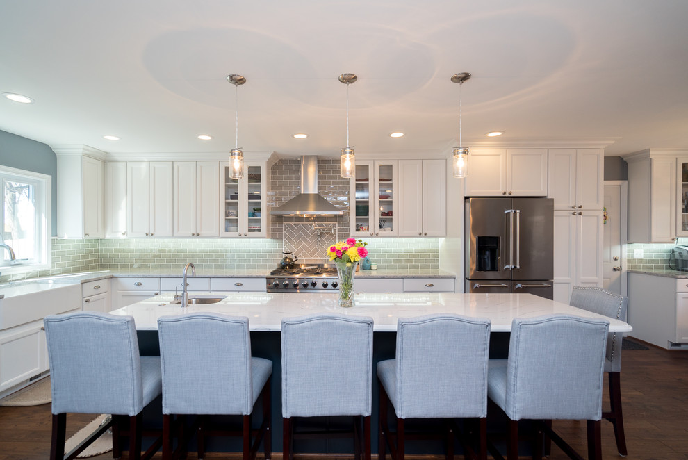 Inspiration for a large transitional l-shaped dark wood floor and brown floor eat-in kitchen remodel in DC Metro with a farmhouse sink, shaker cabinets, white cabinets, quartz countertops, gray backsplash, porcelain backsplash, stainless steel appliances and an island