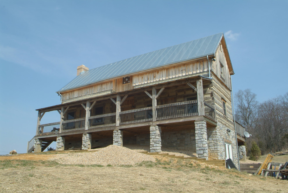 Large rustic brown three-story wood house exterior idea with a hip roof and a metal roof