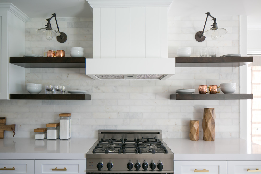 Design ideas for a mid-sized country eat-in kitchen in Orange County with white cabinets, white splashback, medium hardwood floors, with island, shaker cabinets, subway tile splashback and stainless steel appliances.