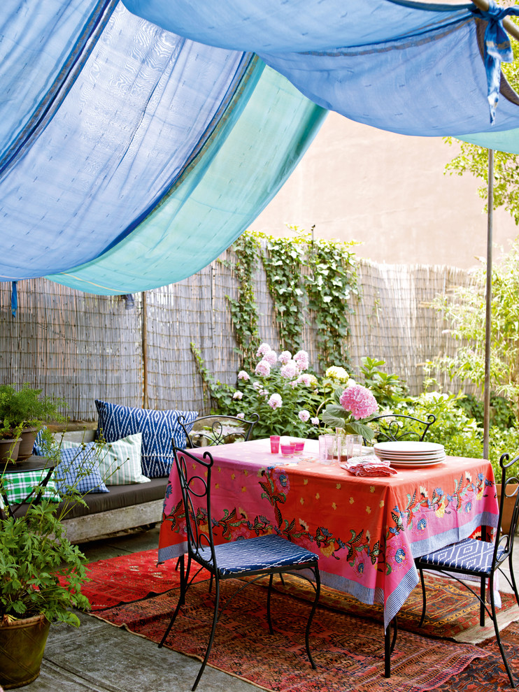 Design ideas for an eclectic patio in Other with an awning.