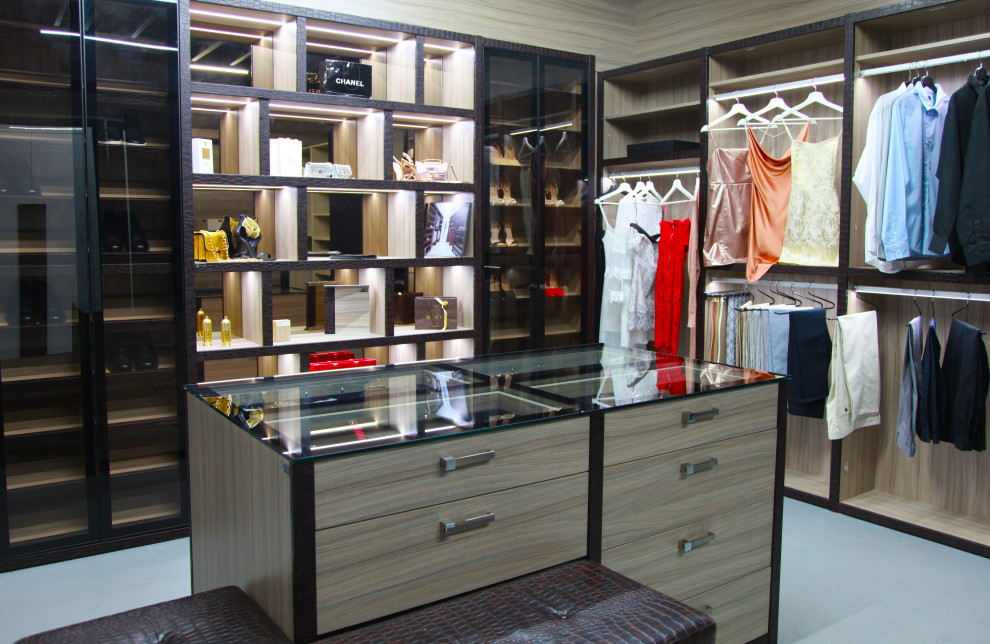 This is an example of a large modern gender-neutral walk-in wardrobe in Miami.