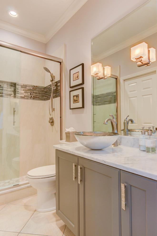 Example of a small transitional 3/4 beige tile and porcelain tile ceramic tile and beige floor alcove shower design in Miami with flat-panel cabinets, gray cabinets, a two-piece toilet, beige walls, a vessel sink and marble countertops