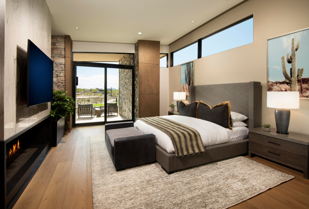 На фото: огромная хозяйская спальня в стиле модернизм с белыми стенами, светлым паркетным полом и горизонтальным камином