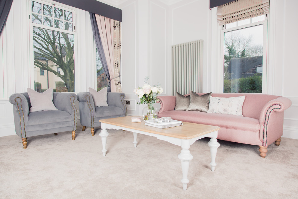 Medium sized traditional formal living room with grey walls, carpet, a wood burning stove, a stone fireplace surround, a wall mounted tv and beige floors.