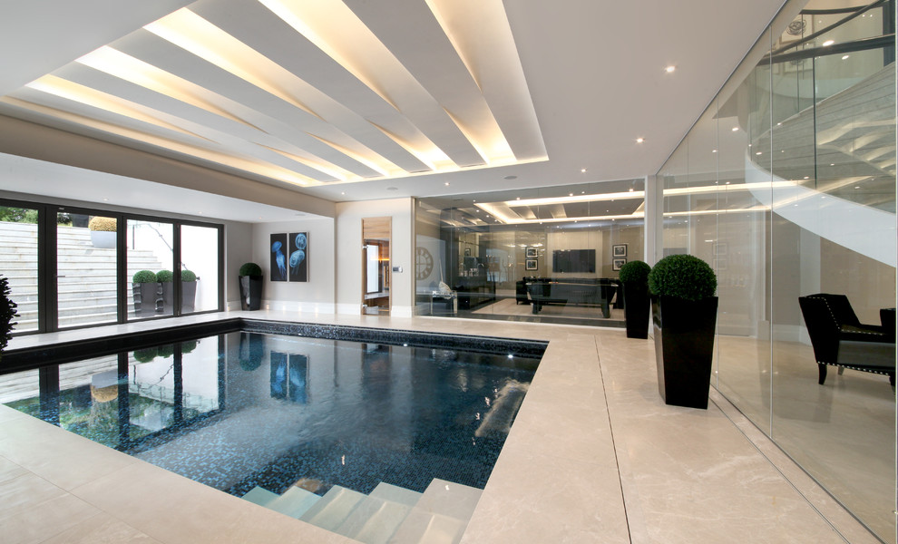 Transitional indoor rectangular pool in Surrey.