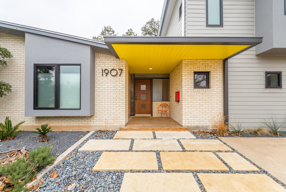 This is an example of a large midcentury entryway in Austin.