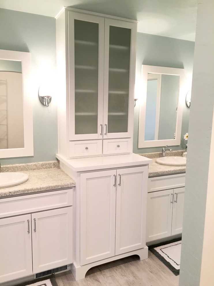 Design ideas for a large arts and crafts master bathroom in Other with recessed-panel cabinets, white cabinets, a curbless shower, blue walls, vinyl floors and a drop-in sink.