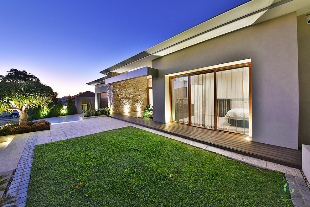Photo of a large contemporary one-storey brick beige house exterior in Perth.